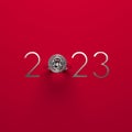 Elegant 2023 New Year design template with luxury diamond engagement ring on a red background.