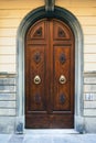 Elegant old double door entrance of brick pink building in Europe. Vintage wooden doorway of ancient stone house. Simple Royalty Free Stock Photo