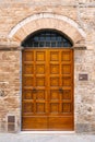 Elegant old double door entrance of brick pink building in Europe. Vintage wooden doorway of ancient stone house. Simple Royalty Free Stock Photo