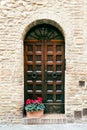 Elegant old double door entrance of building in Europe. Vintage wooden doorway of ancient stone house with a pot of Royalty Free Stock Photo