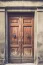 Elegant old double door entrance of building in Europe. Vintage wooden doorway of ancient stone house. Simple brown wood Royalty Free Stock Photo