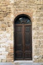 Elegant old double door entrance of building in Europe. Vintage wooden doorway of ancient stone house. Simple brown wood Royalty Free Stock Photo