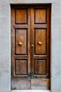 Elegant old double door entrance of building in Europe. Vintage wooden doorway of ancient stone house. Simple brown wood Royalty Free Stock Photo