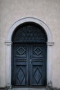 Elegant old double door entrance of building in Europe. Vintage wooden doorway and stucco fretwork wall of ancient stone Royalty Free Stock Photo