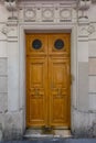 Elegant old double door entrance of building in Paris France. Vintage wooden doorway and stucco fretwork wall. Royalty Free Stock Photo