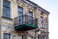 Elegant old ruined balcony with wrought iron railings on facade of an abandoned building in Kiev, Ukraine. View on facade of an Royalty Free Stock Photo