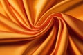 Elegant orange fabric backdrop. Soft silk texture. Satin cloth with pleats. Smooth, shiny material