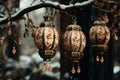 Elegant ornate lanterns hanging from a snowy branch, adorned with delicate patterns and colorful beads.