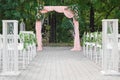 Elegant Outdoor Altar: Wedding Arch Adorned with Beautiful Roses and Fresh Flowers