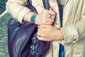 Elegant outfit. Closeup of brown leather bag handbag in hand of stylish woman. Fashionable girl in the street. Casual Royalty Free Stock Photo