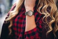 Elegant, trendy outfit Closeup of wrist watch on the hand of stylish woman. Fashionable girl on the street. Female fashion. Royalty Free Stock Photo