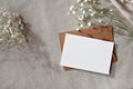 Elegant pastel business, branding template, blank paper card with mock up copy space, envelope and flowers on neutral beige Royalty Free Stock Photo