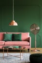 Elegant pastel pink and emerald green interior with sofa and coffee table