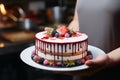 Elegant pastry mastery hands cradle a divine mousse cake