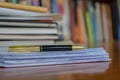 Elegant pen resting on documents in a library or office Royalty Free Stock Photo