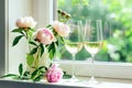 Elegant Peonies and Sparkling Wine Glasses by a Sunny Window Sill