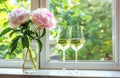 Elegant Peonies and Sparkling Wine Glasses by a Sunny Window Sill