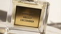 Elegant Perfume Bottle with Hello December Label Royalty Free Stock Photo