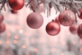 Elegant pink Christmas tree baubles hanging from snow covered branches Royalty Free Stock Photo