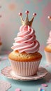 Elegant pink cupcake with crown topping on decorative plate Royalty Free Stock Photo