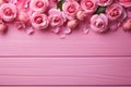 Elegant pink roses form a charming frame against a pink wooden backdrop