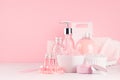 Elegant pink skin and body care products - cream, rose oil, liquid soap, salt, cotton towel and box - cosmetic accessories. Royalty Free Stock Photo