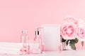 Elegant pink skin, body care products - cream, rose oil, liquid soap, salt, cotton towel - cosmetic accessories, romantic flowers. Royalty Free Stock Photo