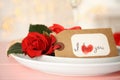 Elegant place setting for romantic dinner on pink table, closeup. Valentine`s day celebration Royalty Free Stock Photo
