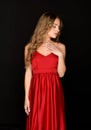 Elegant poised young woman modelling a stylish red dress Royalty Free Stock Photo