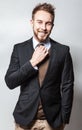 Elegant & Positive young handsome man in costume. Studio fashion portrait.