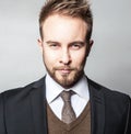 Elegant & Positive young handsome man in costume. Studio fashion portrait.