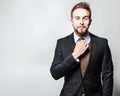 Elegant & Positive young handsome man in costume. Studio fashion portrait.