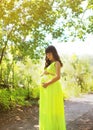 Elegant pregnant woman in dress outdoors