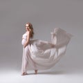 Elegant pregnant woman in a white flying dress Royalty Free Stock Photo