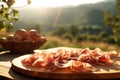 Elegant prosciutto display, with a Tuscan vineyard softly blurred in the background.