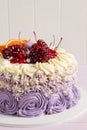Elegant purple rosette cake decorated with fruit