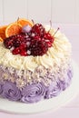 Elegant purple rosette cake decorated with fruit