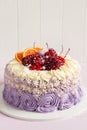 Elegant purple rosette cake decorated with fruit