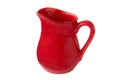 An elegant red ceramic jug or pitcher for milk isolated on a white background. Clipping path. Clay tableware. Space for text. Royalty Free Stock Photo