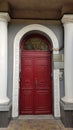 Arch entrance to elegant red door of historic building in European city Odessa of Ukraine Royalty Free Stock Photo