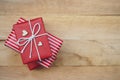 Elegant red gift box stack decorated with mini heart figure on wood background, valentine love present concept Royalty Free Stock Photo