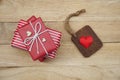 Elegant red gift box stack decorated with mini heart figure on wood background, valentine love present concept Royalty Free Stock Photo