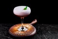 Elegant red ladies` cocktail with pink foam in a beautiful glass on a wooden carved round board Royalty Free Stock Photo