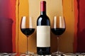 Elegant red wine bottle and two glasses set against a vibrant abstract background Royalty Free Stock Photo