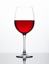 Elegant Red Wine in a Clear Glass Against a Bright White Background with Subtle Reflection Royalty Free Stock Photo