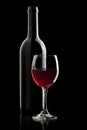 Elegant red wine glass and a wine bottle Royalty Free Stock Photo