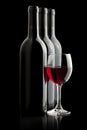 Elegant red wine glass and a wine bottles Royalty Free Stock Photo