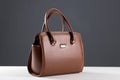 Elegant reptile leather light brown women bag on white table and
