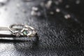 Elegant ring on black leather surface. Precious jewellery Royalty Free Stock Photo