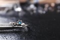 Elegant ring on black  surface, closeup view. Precious jewellery Royalty Free Stock Photo